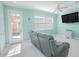 Bright and airy living room features a comfortable seating area and a door to the patio at 9635 Fenrose Ter, Orlando, FL 32827