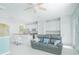 Open-concept living space with a kitchen, breakfast bar, and comfortable seating area at 9635 Fenrose Ter, Orlando, FL 32827