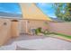 Enclosed brick paved patio features drought resistant landscaping and shade sail at 9635 Fenrose Ter, Orlando, FL 32827