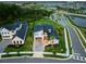 Aerial view of a modern home with lush landscaping, and a dark-colored roof at 9877 Laurel Berry Dr, Orlando, FL 32827