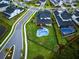 Aerial view showcasing a home with a large backyard, a pool, and manicured lawn at 9877 Laurel Berry Dr, Orlando, FL 32827