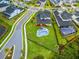 A beautiful aerial view of a modern home, showcasing the pool, fenced yard, and neighborhood at 9877 Laurel Berry Dr, Orlando, FL 32827