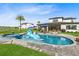 Spacious backyard with a pool, spa, custom statue, and patio seating, ideal for outdoor entertaining at 9877 Laurel Berry Dr, Orlando, FL 32827