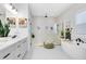 Luxurious bathroom featuring a soaking tub, frameless shower, and double vanity at 9877 Laurel Berry Dr, Orlando, FL 32827