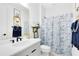 Charming bathroom with unique decor, stylish vanity, and shower with blue-patterned curtain at 9877 Laurel Berry Dr, Orlando, FL 32827