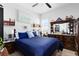 Cozy bedroom featuring a comfortable bed with blue bedding and wooden furniture at 9877 Laurel Berry Dr, Orlando, FL 32827