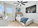 Bright bedroom with coastal decor, natural light, and comfortable furnishings at 9877 Laurel Berry Dr, Orlando, FL 32827
