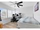 Bedroom featuring a large window, ceiling fan, and desk area with multiple screens at 9877 Laurel Berry Dr, Orlando, FL 32827