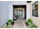 Inviting front entrance with a double door entry, manicured landscaping, and a cozy seating area for guests to enjoy at 9877 Laurel Berry Dr, Orlando, FL 32827