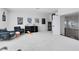 Large game room with comfortable seating, classic movie posters, and an arcade machine at 9877 Laurel Berry Dr, Orlando, FL 32827
