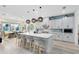Bright, modern kitchen with a large island, stylish pendant lighting, and stainless steel appliances, perfect for cooking at 9877 Laurel Berry Dr, Orlando, FL 32827