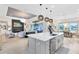 Bright kitchen with large island, modern lighting, and open floor plan at 9877 Laurel Berry Dr, Orlando, FL 32827