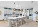 Well-lit kitchen featuring a center island with chairs and modern stainless appliances at 9877 Laurel Berry Dr, Orlando, FL 32827