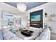 Stylish living room with a cozy fireplace, large TV, modern lighting, and comfortable seating for relaxation and entertainment at 9877 Laurel Berry Dr, Orlando, FL 32827
