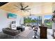 Inviting outdoor living space with fireplace, tv, wet bar, and views of the pool at 9877 Laurel Berry Dr, Orlando, FL 32827
