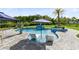 Resort-style pool with in-water loungers, lush landscaping, and a fun dolphin statue at 9877 Laurel Berry Dr, Orlando, FL 32827