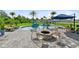 Beautiful pool area featuring a fire pit, sun loungers, and lush tropical landscaping at 9877 Laurel Berry Dr, Orlando, FL 32827