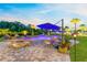 Relaxing backyard pool with comfortable seating around the brick firepit for outdoor relaxation at 9877 Laurel Berry Dr, Orlando, FL 32827