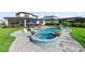 Resort-style backyard showcasing a sparkling pool, hot tub, and lush landscaping, creating a private oasis for relaxation and enjoyment at 9877 Laurel Berry Dr, Orlando, FL 32827