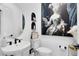 Chic powder room with a modern sink, toilet, and decorative artwork, showcasing a stylish design at 9877 Laurel Berry Dr, Orlando, FL 32827