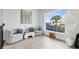 Cozy sitting area with comfortable chairs, natural light, and neighborhood views at 9877 Laurel Berry Dr, Orlando, FL 32827