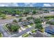 An aerial view of single Gathering homes in a suburban community near a highway surrounded by mature trees at 9931 Cypress Knee Cir, Orlando, FL 32825