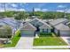 Overhead view of a well-kept home with a green lawn, an attached garage, and a neatly landscaped front yard at 9931 Cypress Knee Cir, Orlando, FL 32825