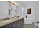 Bathroom boasts a double vanity, modern soaking tub, and stylish black and white patterned floor tiles at 9931 Cypress Knee Cir, Orlando, FL 32825
