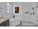 Bathroom featuring a soaking tub, frameless glass shower, and designer tile flooring at 9931 Cypress Knee Cir, Orlando, FL 32825