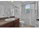 Clean bathroom featuring a tub-shower combination, a dark vanity with a sink, and a window for natural light at 9931 Cypress Knee Cir, Orlando, FL 32825