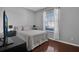Inviting bedroom featuring hardwood floors, a large window, and a cozy bed with a quilted comforter at 9931 Cypress Knee Cir, Orlando, FL 32825