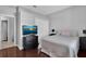 Serene bedroom with hardwood floors, a neutral color scheme, a television, and ample closet space at 9931 Cypress Knee Cir, Orlando, FL 32825