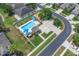 Aerial view features a sparkling community pool, playground, and sport court amenities in a residential neighborhood at 9931 Cypress Knee Cir, Orlando, FL 32825