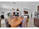 Inviting dining area with a wooden table, leather chairs, and an open view to the living space and kitchen at 9931 Cypress Knee Cir, Orlando, FL 32825