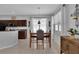 Dining area situated beside a kitchen with dark cabinets and featuring a window at 9931 Cypress Knee Cir, Orlando, FL 32825