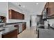 Functional kitchen showcasing wood cabinets, tile flooring, and stainless steel appliances at 9931 Cypress Knee Cir, Orlando, FL 32825