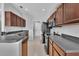 Efficient kitchen featuring wood cabinets, tile flooring, and modern appliances for a functional cooking space at 9931 Cypress Knee Cir, Orlando, FL 32825