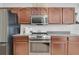 Modern kitchen appliances including a stainless steel oven, microwave, and refrigerator for convenient cooking at 9931 Cypress Knee Cir, Orlando, FL 32825