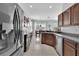 Bright kitchen featuring wood cabinets, tile flooring, and stainless steel appliances with natural light at 9931 Cypress Knee Cir, Orlando, FL 32825