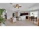 Open-concept living space featuring tile floors, modern furniture, and a partial view of the kitchen at 9931 Cypress Knee Cir, Orlando, FL 32825