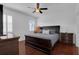Primary bedroom with hardwood floors, ceiling fan, and window with plantation shutters at 9931 Cypress Knee Cir, Orlando, FL 32825