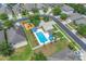 Aerial shot showcases a community pool, playground, and basketball court surrounded by manicured lawns and single Gathering homes at 9931 Cypress Knee Cir, Orlando, FL 32825