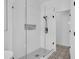 Modern frameless shower featuring designer tiling and matte black hardware at 9931 Cypress Knee Cir, Orlando, FL 32825