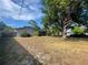 Spacious backyard showcasing a large tree and a screened-in porch, great for enjoying the outdoors at 1001 Arden St, Longwood, FL 32750