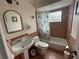 Cozy bathroom with tiled walls, a cactus shower curtain, and a classic pedestal sink at 1001 Arden St, Longwood, FL 32750