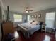 Comfortable bedroom features a cozy bed, stylish decor, and ample natural light from large windows at 1001 Arden St, Longwood, FL 32750