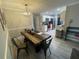 Open-concept space with kitchen access, adjacent to a beautifully staged dining area and modern lighting at 1001 Arden St, Longwood, FL 32750