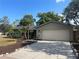 Charming single-story home with a two-car garage, complemented by manicured landscaping and a welcoming driveway at 1001 Arden St, Longwood, FL 32750