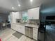 Bright kitchen with white cabinets, granite countertops, and stainless steel appliances with a view to the dining area at 1001 Arden St, Longwood, FL 32750