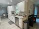 Bright kitchen features white cabinets, granite counters, stainless appliances, and wood-look tile flooring at 1001 Arden St, Longwood, FL 32750